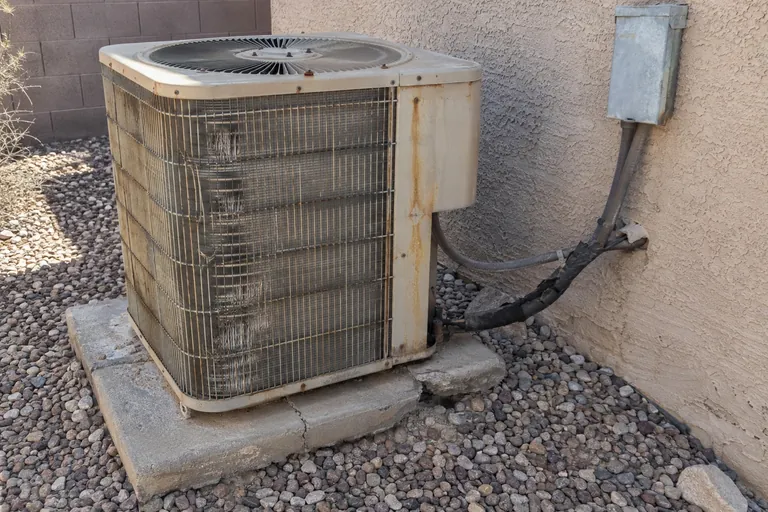 Worn-out AC condenser before replacement in Phoenix, AZ