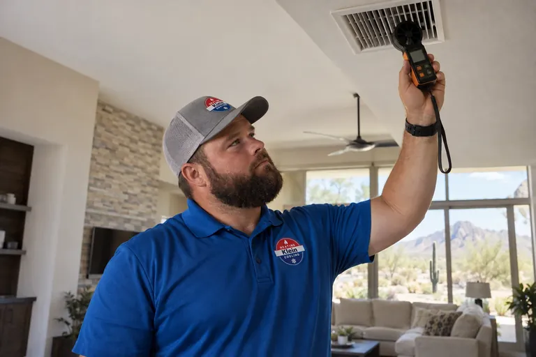 Tomer Klein measuring airflow at a supply vent in Scottsdale, AZ